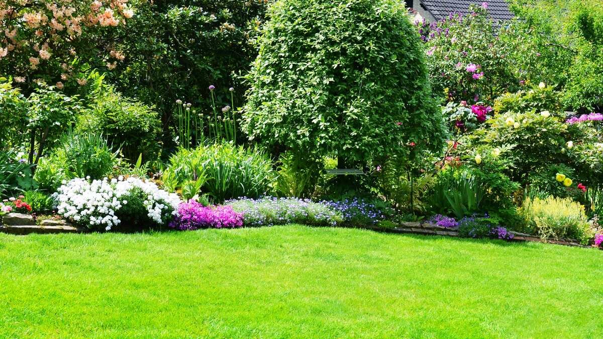 Betreten eines Nachbargrundstücks - Gepflegter blühender Garten mit großer Rasenfläche