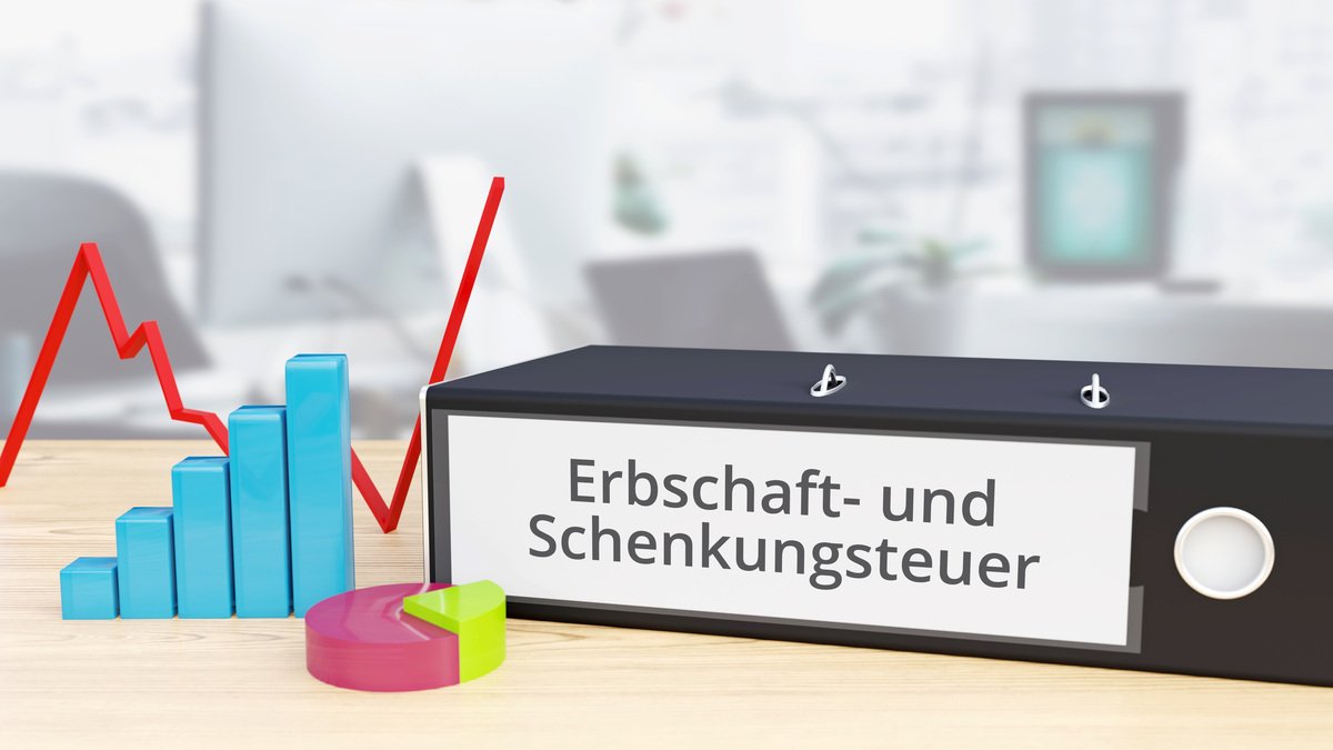 Erbschaft- und Schenkungsteuer – Finanzen/Wirtschaft. Ordner auf Schreibtisch mit Beschriftung neben Diagrammen. Business/Statistik